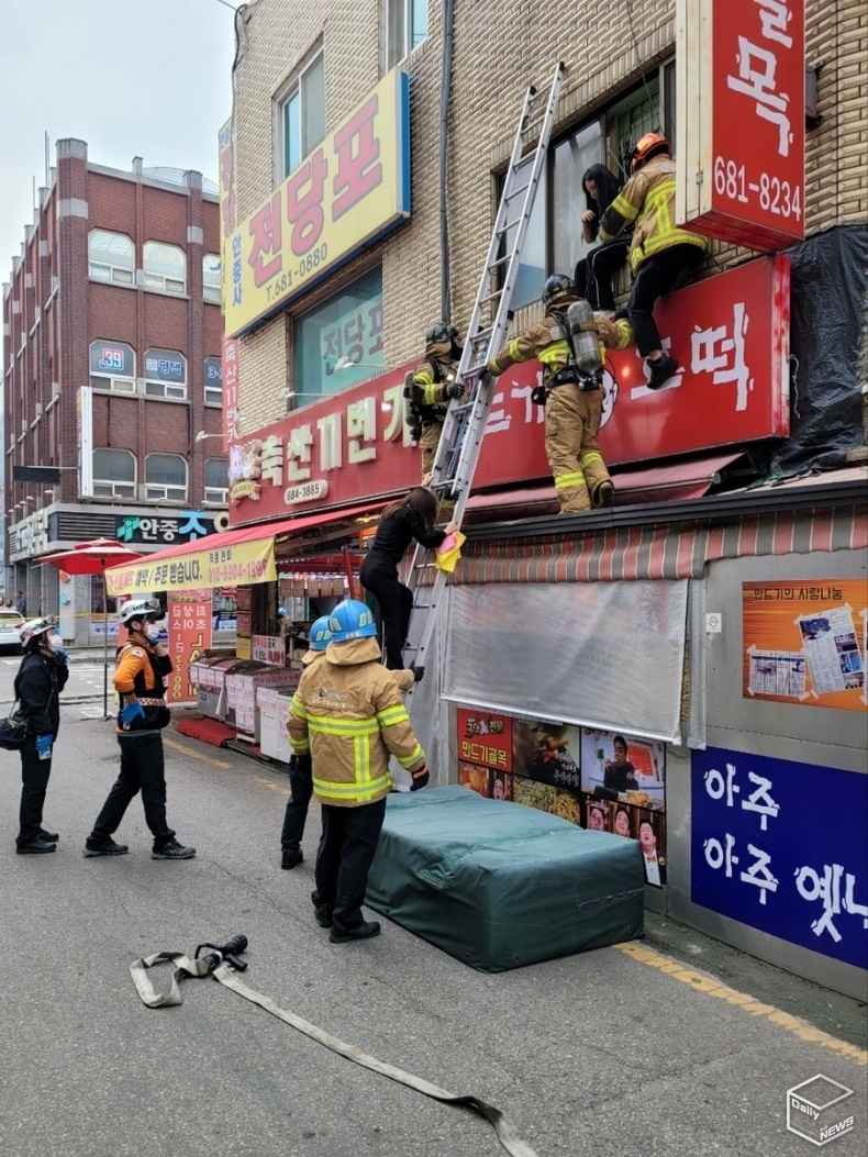 평택소방서 화재진압 요원들에 의해 고립된 한 주민이 구조되고 있다. 